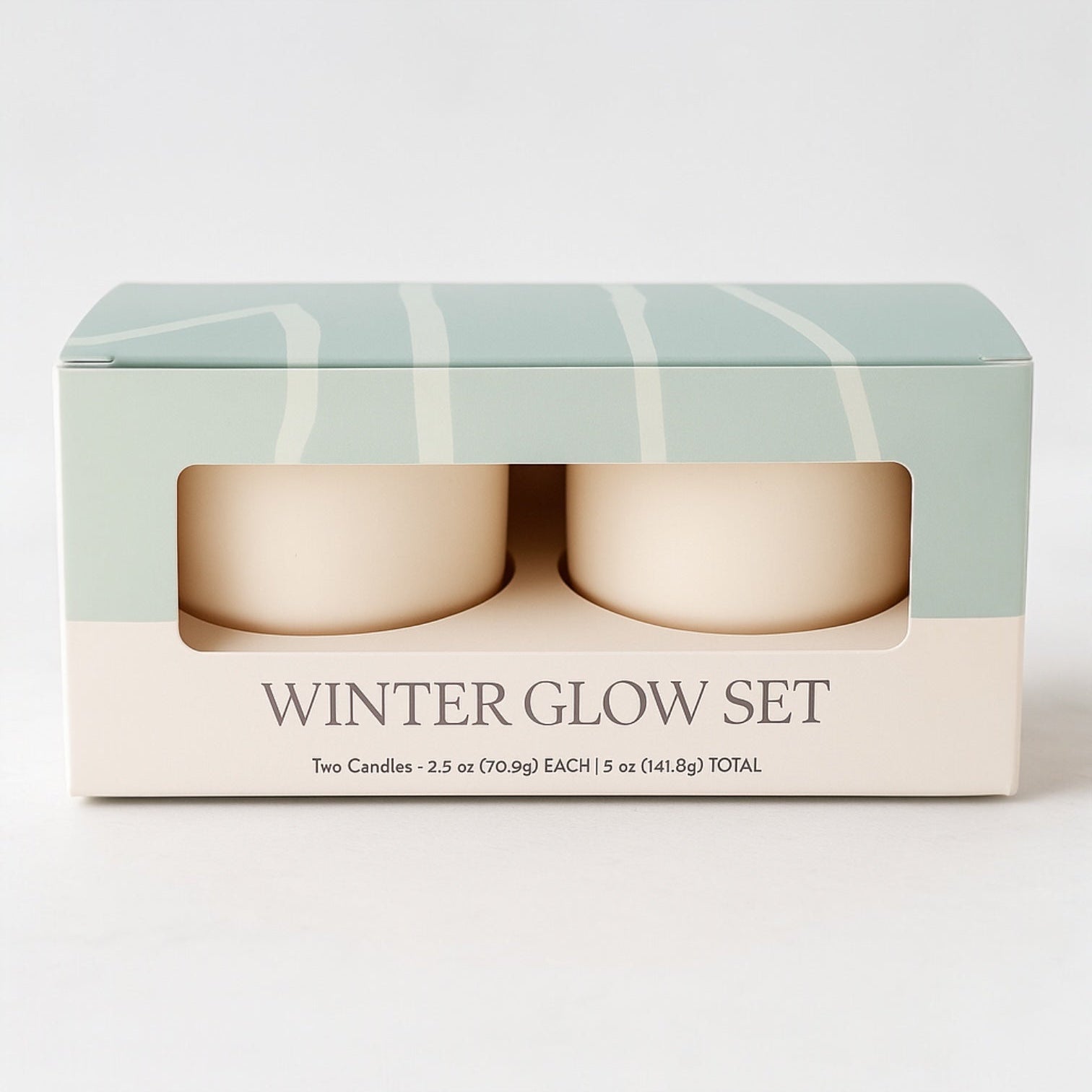 Boxed set of two candles labeled 'Winter Glow Set' on a white background