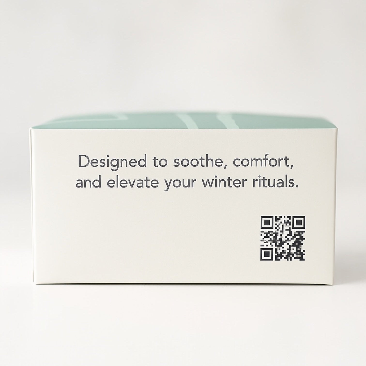 Product packaging with text 'Designed to soothe, comfort, and elevate your winter rituals.' on a white background.